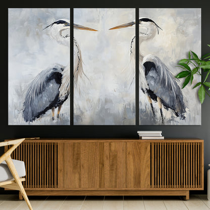 Two herons facing each other on a soft-toned background with blue-grey feathers, perfect for tranquil, coastal or nature-themed interiors.