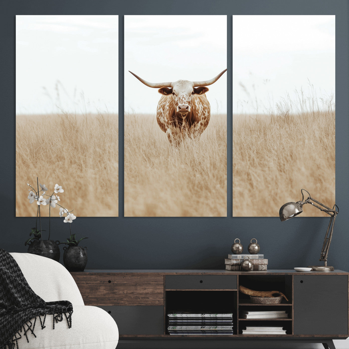 Texas Longhorn bull standing alone in dry grass with neutral tones, ideal for rustic western or cowboy-themed wall decor.
