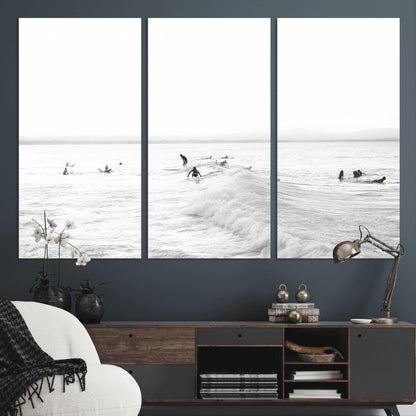 Monochrome photo of surfers riding and waiting on ocean waves, ideal for surf-themed or coastal energy wall decor.