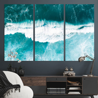 Aerial view of turquoise ocean waves crashing with white foam, perfect for tropical coastal or modern beach-style home decor.