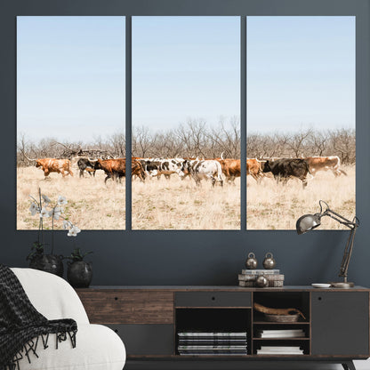 Framed wall art of Texas longhorn cattle walking through a dry, neutral-toned prairie, perfect for rustic farmhouse or western-themed home decor.