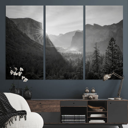 Black and white landscape of Yosemite with sun rays peeking over El Capitan, ideal for moody nature or modern rustic decor.