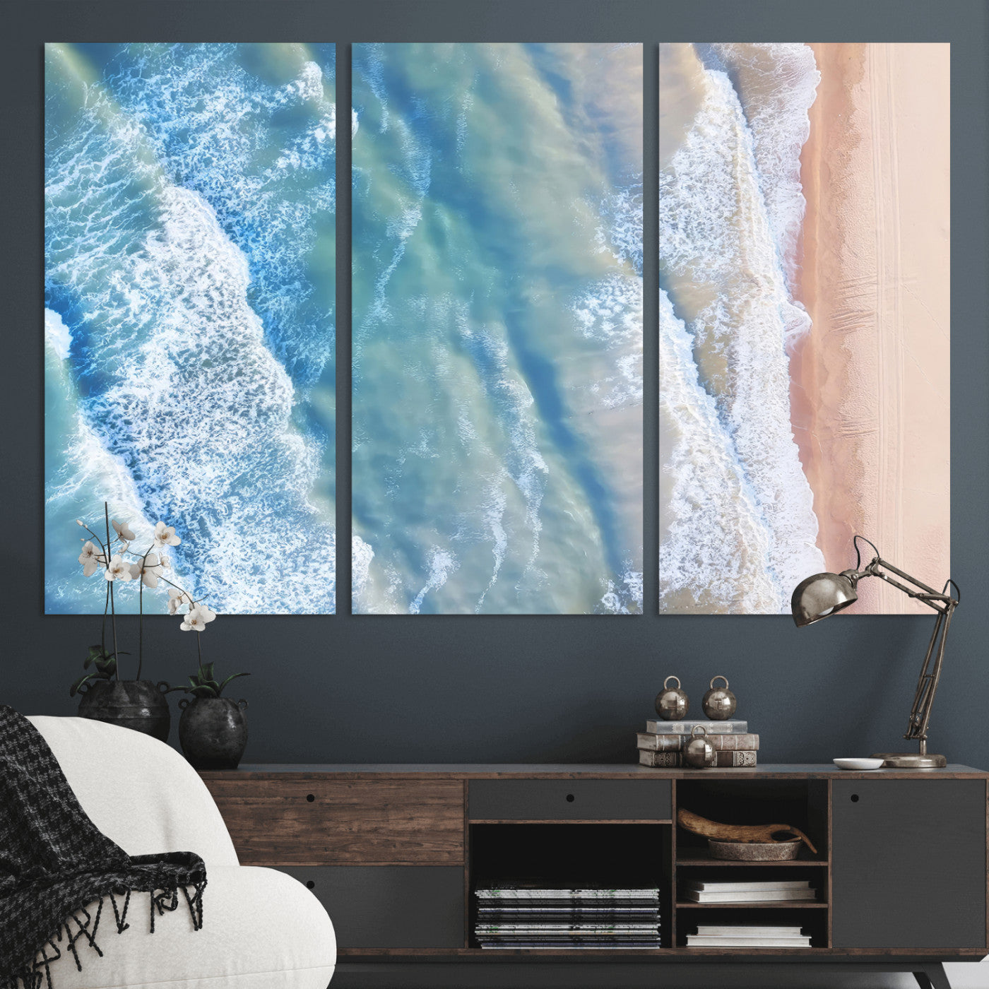 Aerial photo of soft blue waves meeting sandy shore, perfect for modern coastal or beach-themed decor with a light and tranquil aesthetic.