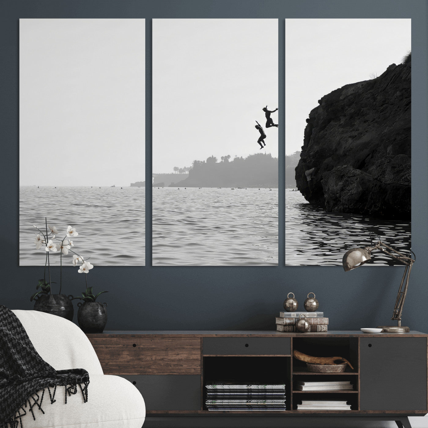 Black and white canvas of two figures cliff jumping into the sea, captured with moody tones, ideal for modern coastal or adventure-themed home decor.   2/2