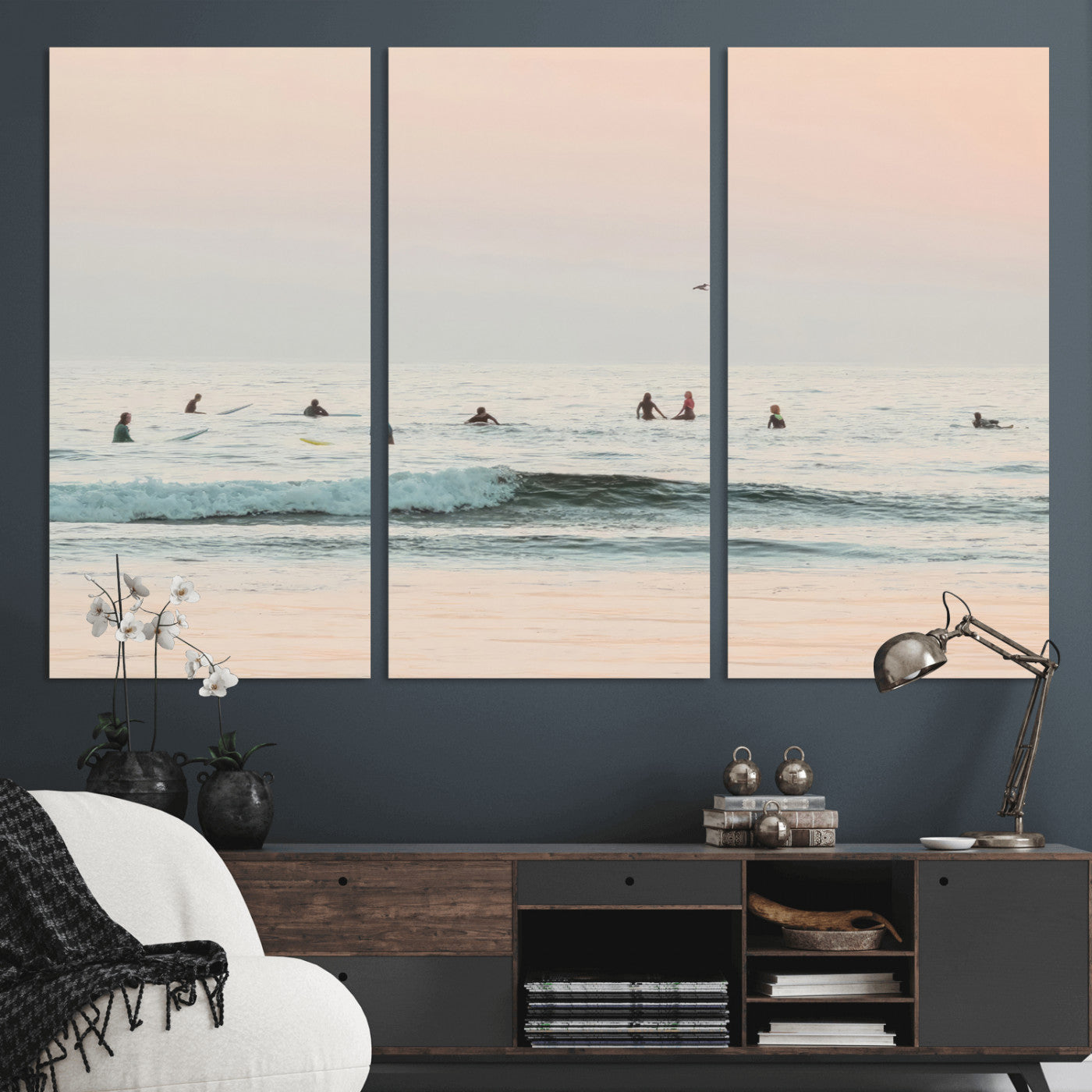 Dreamy photo of surfers waiting on soft pastel waves under a pink sunset sky, ideal for soft coastal minimalist or serene ocean-themed home decor.