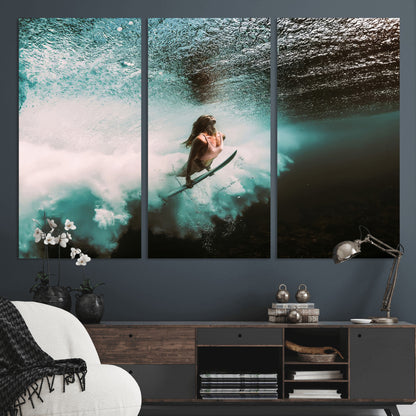 Vibrant underwater photo of a female surfer diving through turquoise waves, perfect for coastal boho or surf-inspired home decor.