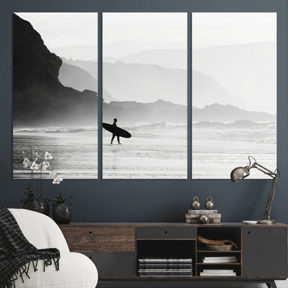 A lone surfer walking along a misty beach with cliffs in the background, carrying their board, capturing a serene and minimal ocean moment.