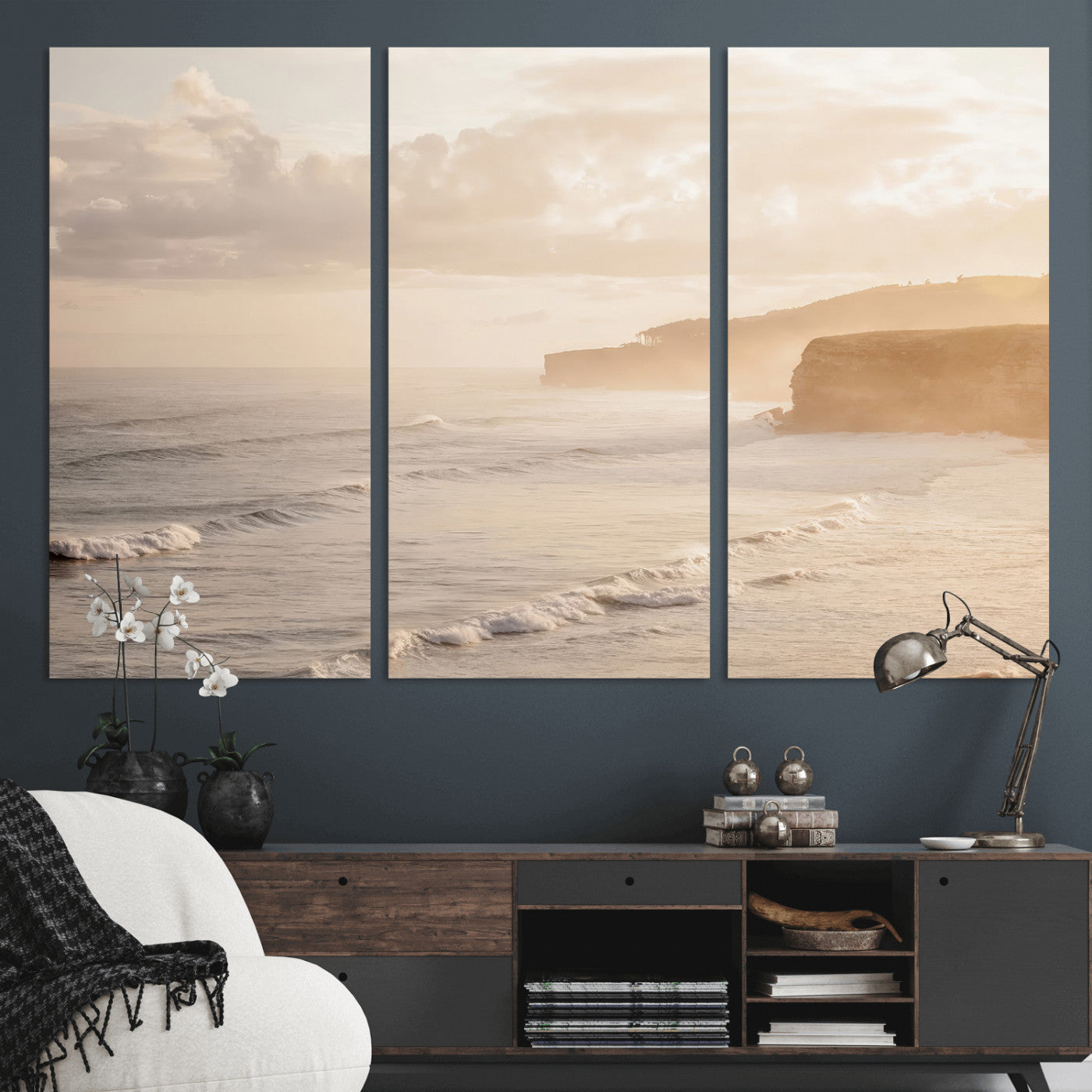 Golden hour seascape with misty cliffs and gentle waves rolling towards the shore, capturing a tranquil and warm coastal atmosphere.