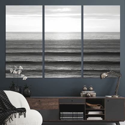 Minimalist black and white ocean view with layered waves reflecting sunlight, evoking a sense of calm and coastal serenity.