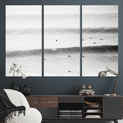 A monochrome photograph of swimmers gliding through gentle ocean waves, evoking a sense of calm and movement.