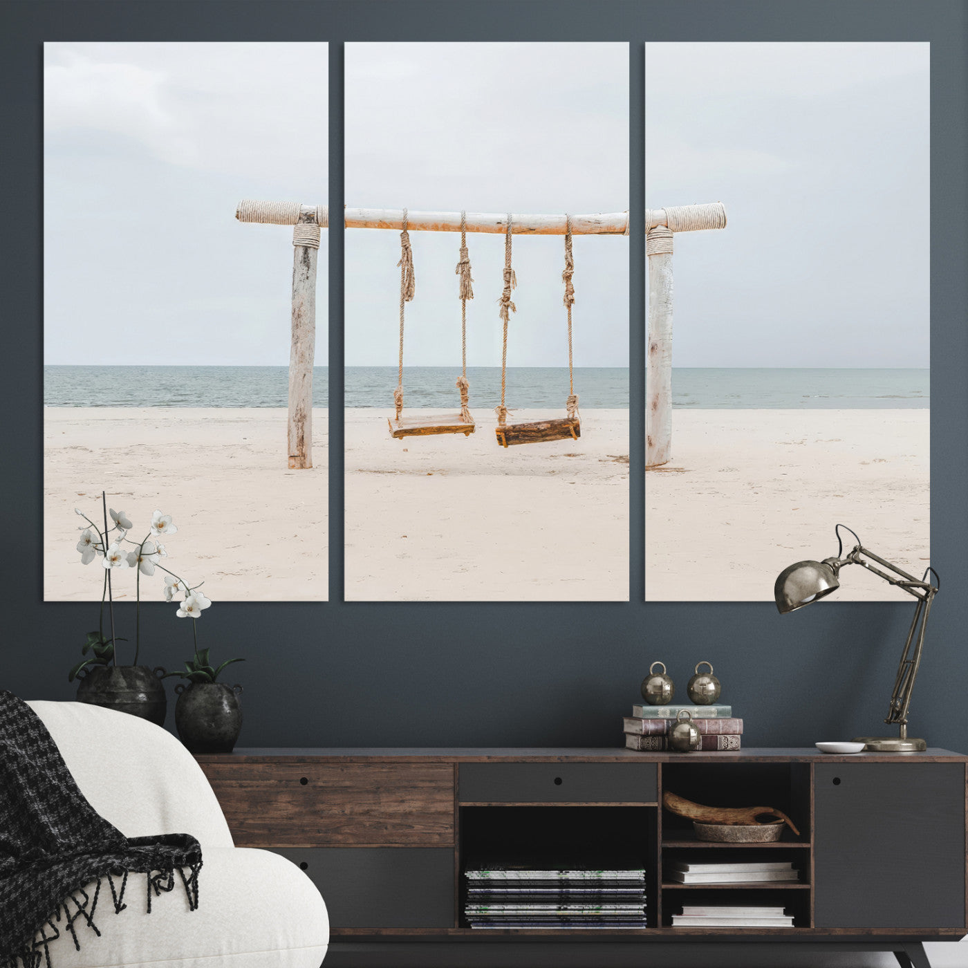 A rustic wooden beach swing stands on a serene sandy shore with an ocean horizon in the background, creating a tranquil and dreamy coastal escape.