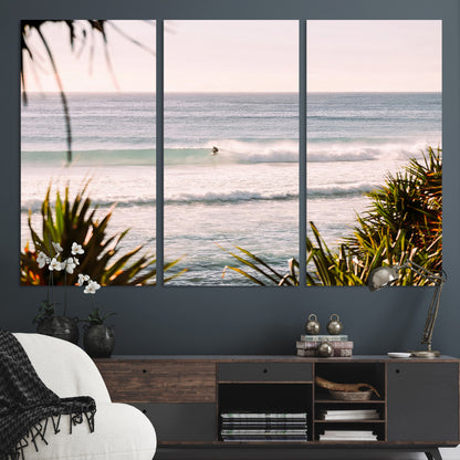 Canvas of a lone surfer riding a pastel wave at sunrise, perfect for tropical or coastal-themed spaces with a relaxed, airy vibe.