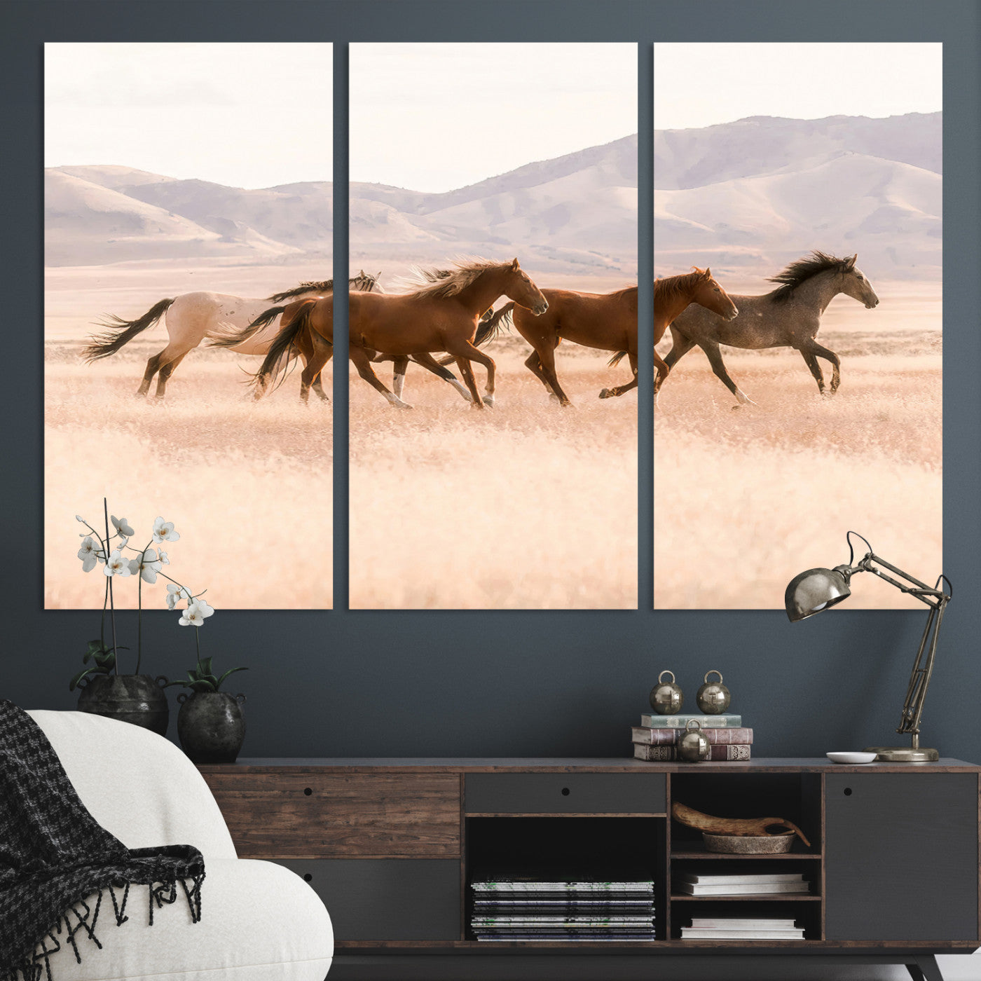 A herd of wild horses galloping through a sunlit desert plain with mountains in the background, perfect for rustic or western-themed wall decor.