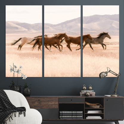 A herd of wild horses galloping through a sunlit desert plain with mountains in the background, perfect for rustic or western-themed wall decor.