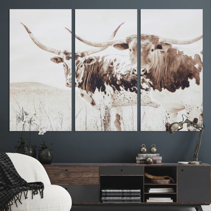Two longhorn cows standing in a sepia-toned pasture with soft light, ideal for rustic or farmhouse-themed neutral wall decor.