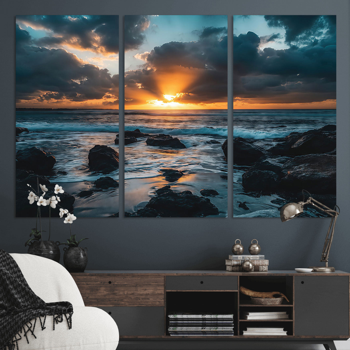 An awe-inspiring sunset over the ocean with rays of light piercing through dramatic clouds, creating a beautiful seascape with rocks in the foreground.