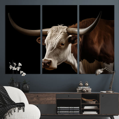 "Close-up of a brown and white longhorn cow with prominent curved horns against a black background."