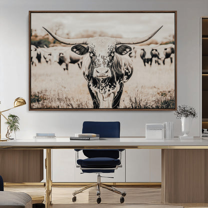 Canvas of a speckled Texas longhorn standing boldly in a field with a herd behind, perfect for rustic western or farmhouse wall decor.