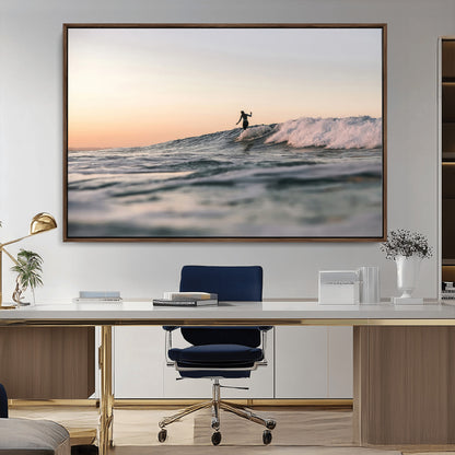 Framed canvas of a female surfer balancing on a wave at sunset, perfect for serene surf or ocean-inspired coastal decor.