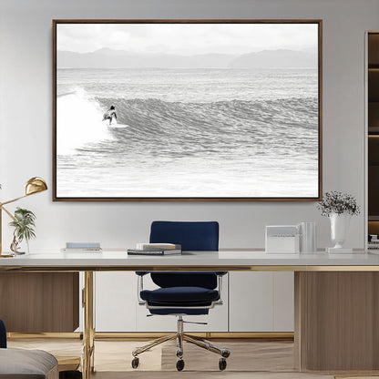 Monochrome photo of a surfer riding a wave with distant mountains, ideal for coastal motion or black and white surf-themed wall decor.
