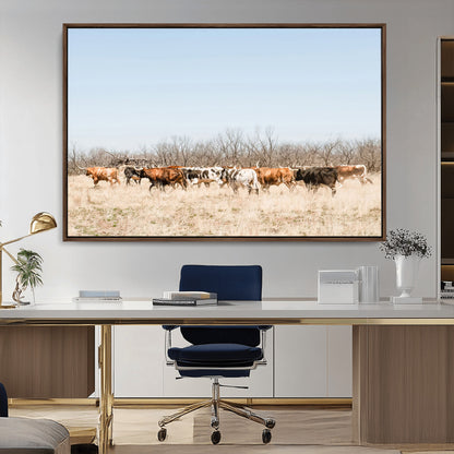 Framed wall art of Texas longhorn cattle walking through a dry, neutral-toned prairie, perfect for rustic farmhouse or western-themed home decor.