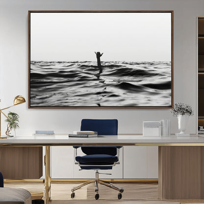 Black and white ocean with a hand making a surfer sign among dark waves, creating a dramatic and minimalist seascape with bold contrast.