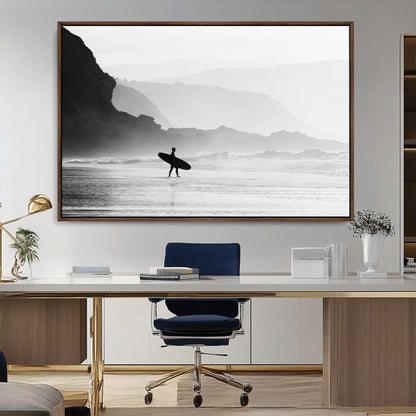 A lone surfer walking along a misty beach with cliffs in the background, carrying their board, capturing a serene and minimal ocean moment.
