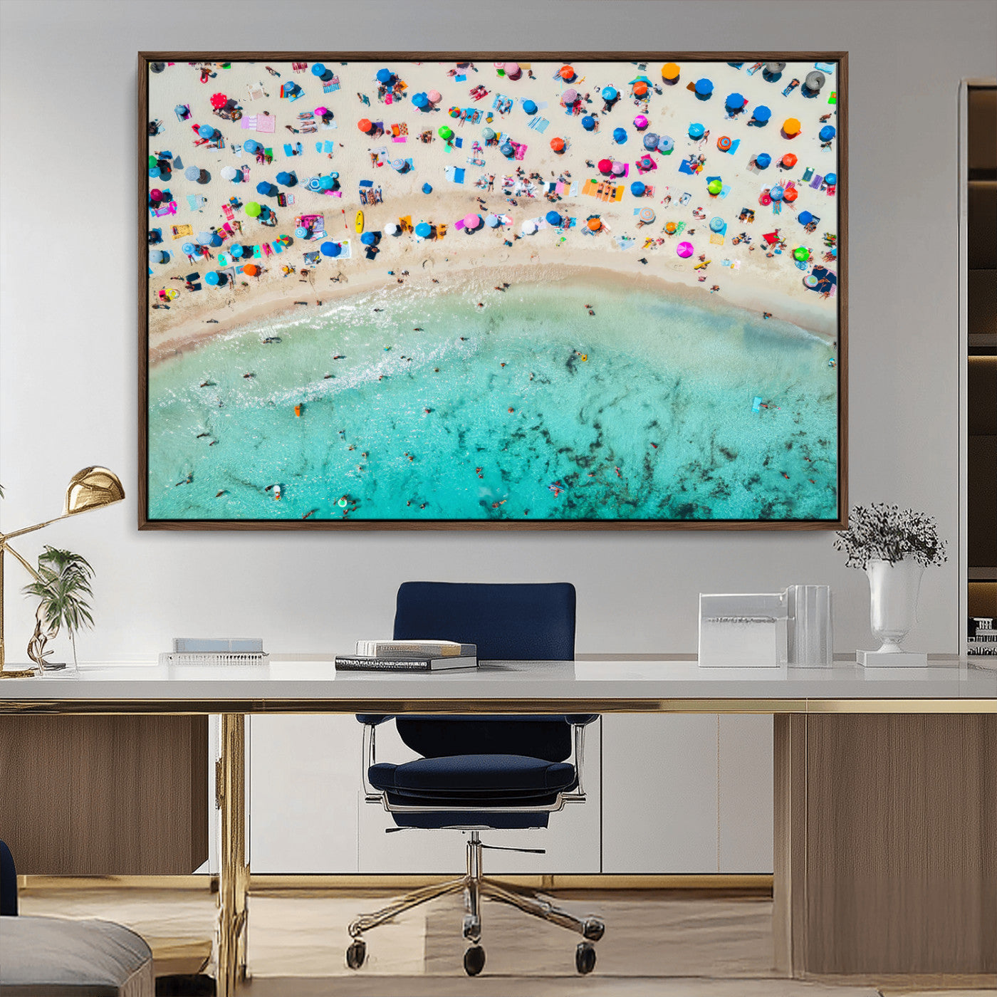 Aerial view of a vibrant beach filled with colorful umbrellas and people enjoying the turquoise ocean, capturing a lively summer vacation scene.
