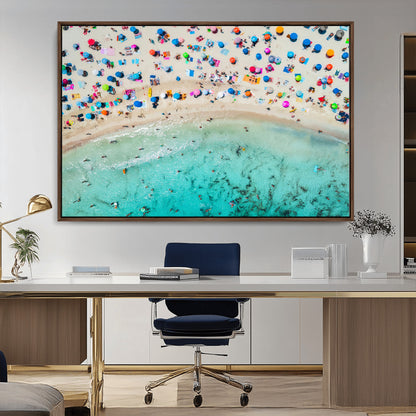 Aerial view of a vibrant beach filled with colorful umbrellas and people enjoying the turquoise ocean, capturing a lively summer vacation scene.