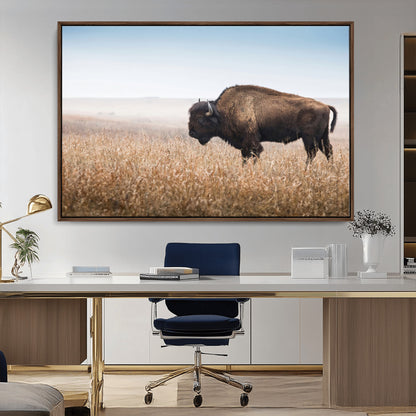 A majestic bison standing in an open prairie field, its strong form blending into the golden grass under a vast blue sky, evoking the wild spirit of the American plains.