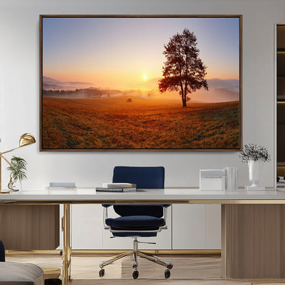 A tranquil landscape at sunrise with a mist-covered field and a lone tree, creating a peaceful and natural atmosphere.