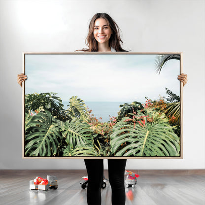Monstera leaves and tropical flowers framing a calm ocean view, ideal for tropical coastal or exotic jungle-style interior wall decor.