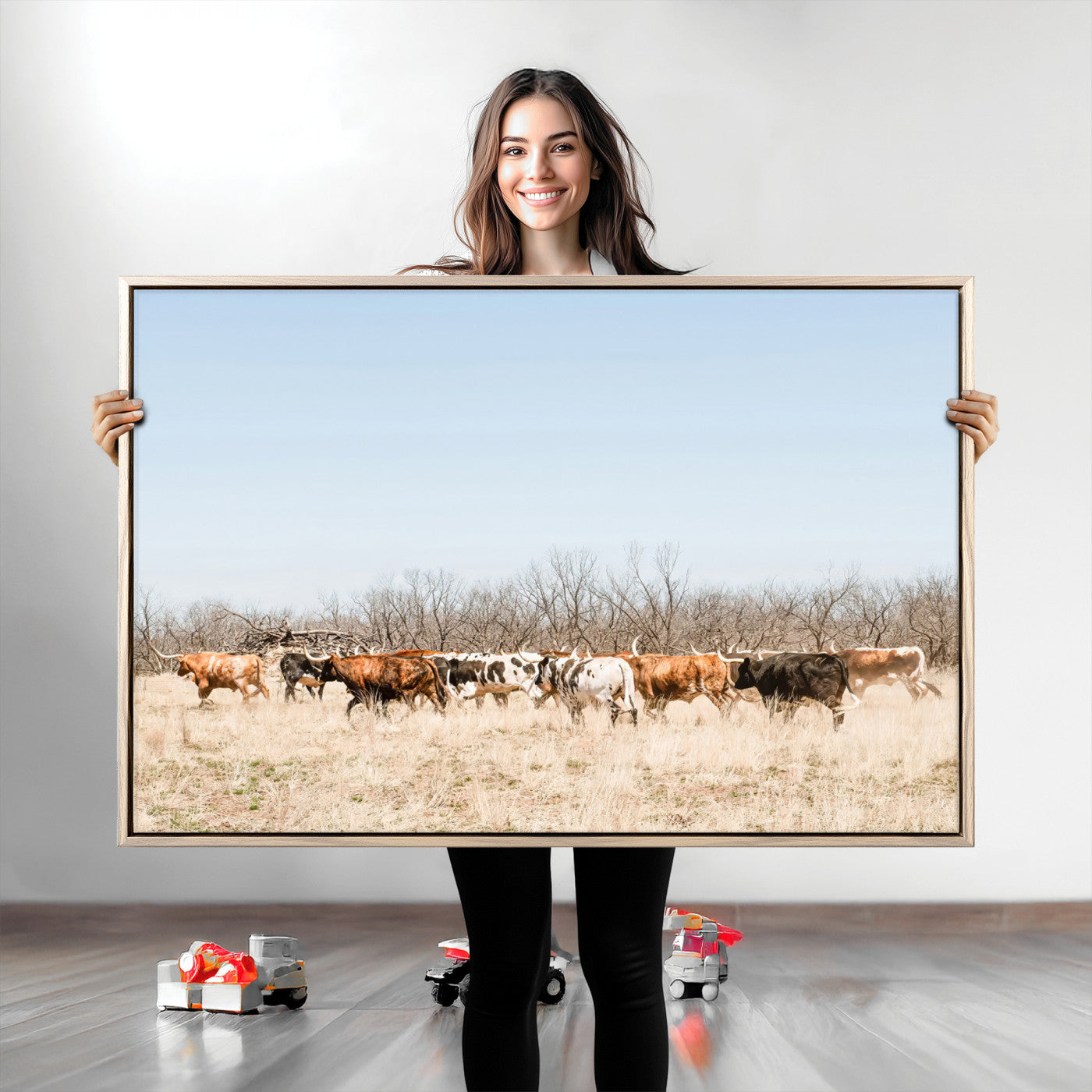 Framed wall art of Texas longhorn cattle walking through a dry, neutral-toned prairie, perfect for rustic farmhouse or western-themed home decor.