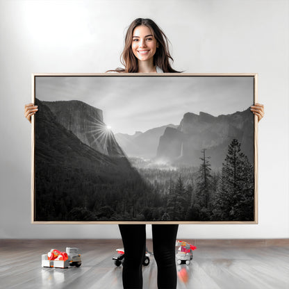 Black and white landscape of Yosemite with sun rays peeking over El Capitan, ideal for moody nature or modern rustic decor.