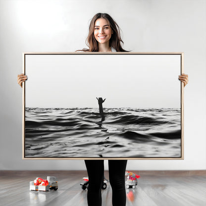 Black and white ocean with a hand making a surfer sign among dark waves, creating a dramatic and minimalist seascape with bold contrast.