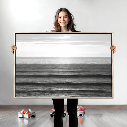 Minimalist black and white ocean view with layered waves reflecting sunlight, evoking a sense of calm and coastal serenity.