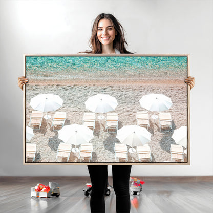 A bright beach scene with white umbrellas, pastel sand, and turquoise waters, creating a tranquil coastal vibe, perfect for beach house or summer decor.