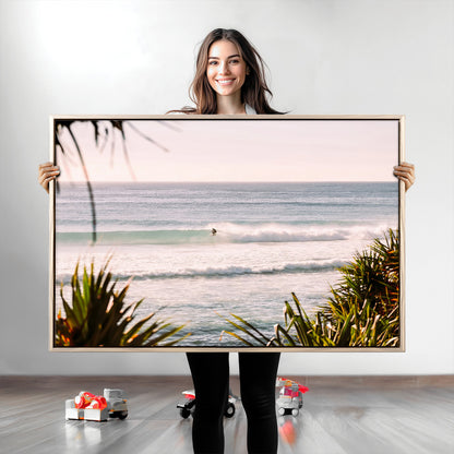 Canvas of a lone surfer riding a pastel wave at sunrise, perfect for tropical or coastal-themed spaces with a relaxed, airy vibe.