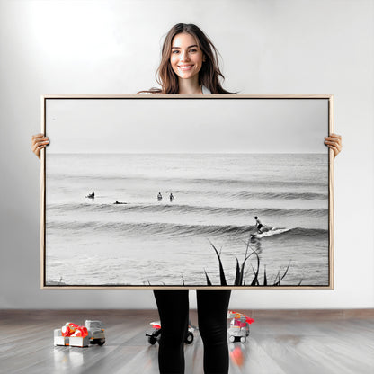 Monochrome canvas of surfers on calm ocean waves, ideal for minimalist coastal or beach-inspired interior decor.