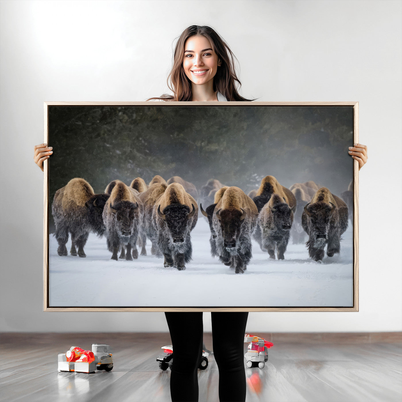 A herd of American bisons walking through deep snow in a forest, evoking a powerful rustic wilderness mood for western-style interiors.