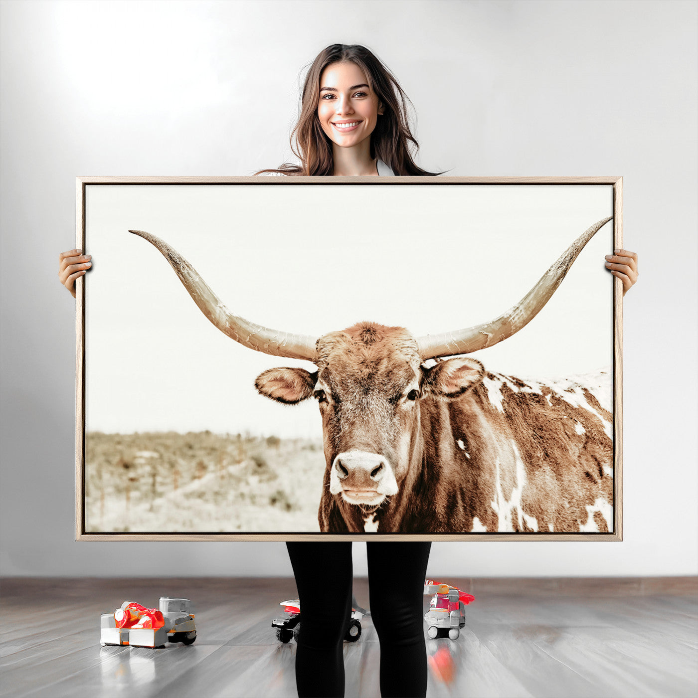 A Texas longhorn bull with wide horns, standing in a dry field under soft light, ideal for rustic farmhouse or western-themed interiors.