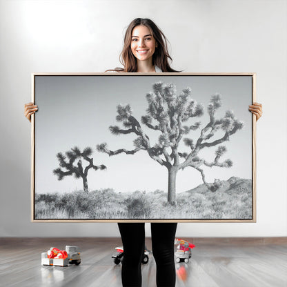 Black and white Joshua tree in a desert landscape with soft light and dry brush, perfect for rustic or minimalist home decor.