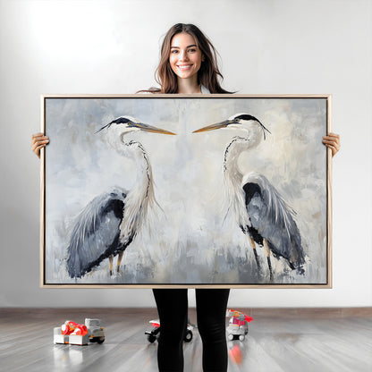Two herons facing each other on a soft-toned background with blue-grey feathers, perfect for tranquil, coastal or nature-themed interiors.