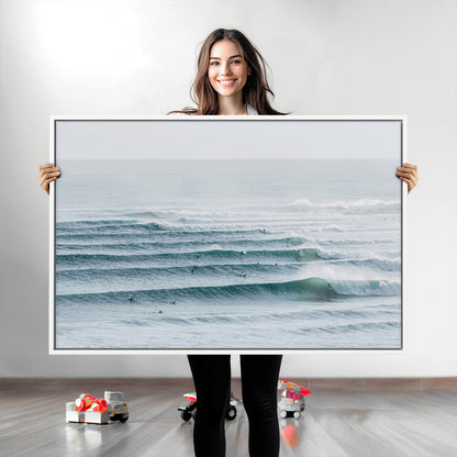 High-angle view of surfers lining up across layered ocean waves, ideal for minimal coastal or surf-inspired room decor.
