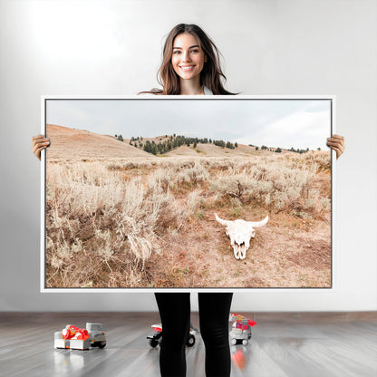 Rustic bull skull on dry sagebrush field under soft light, ideal for western minimal or desert prairie-style wall decoration.