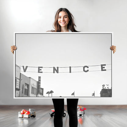 Black and white photo of Venice Beach sign and palm-lined street, perfect for urban coastal or minimalist LA-inspired wall decoration.