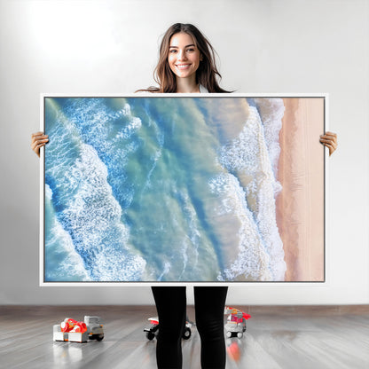 Aerial photo of soft blue waves meeting sandy shore, perfect for modern coastal or beach-themed decor with a light and tranquil aesthetic.