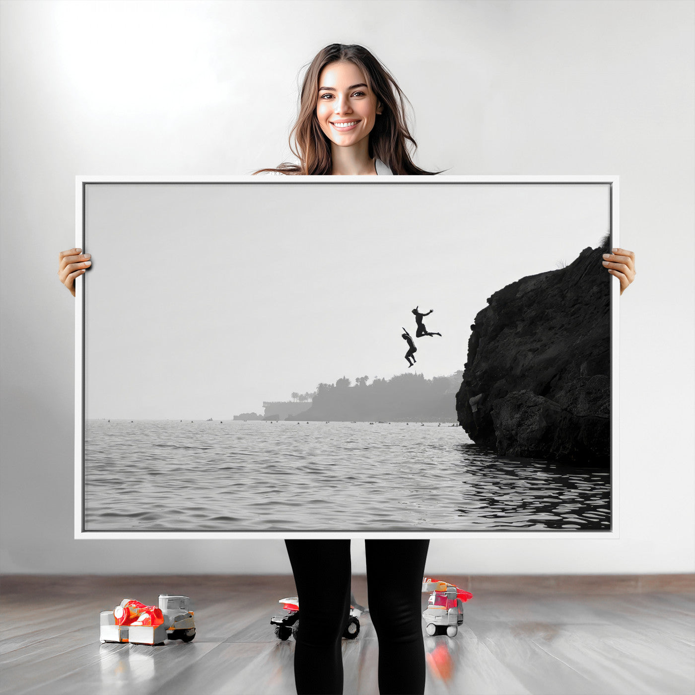 Black and white canvas of two figures cliff jumping into the sea, captured with moody tones, ideal for modern coastal or adventure-themed home decor.   2/2
