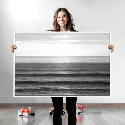 Minimalist black and white ocean view with layered waves reflecting sunlight, evoking a sense of calm and coastal serenity.