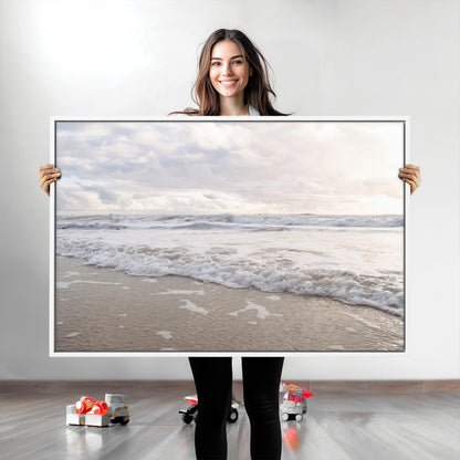 Peaceful ocean waves rolling onto the sandy shore under soft light, perfect for neutral or coastal minimalist decor themes.